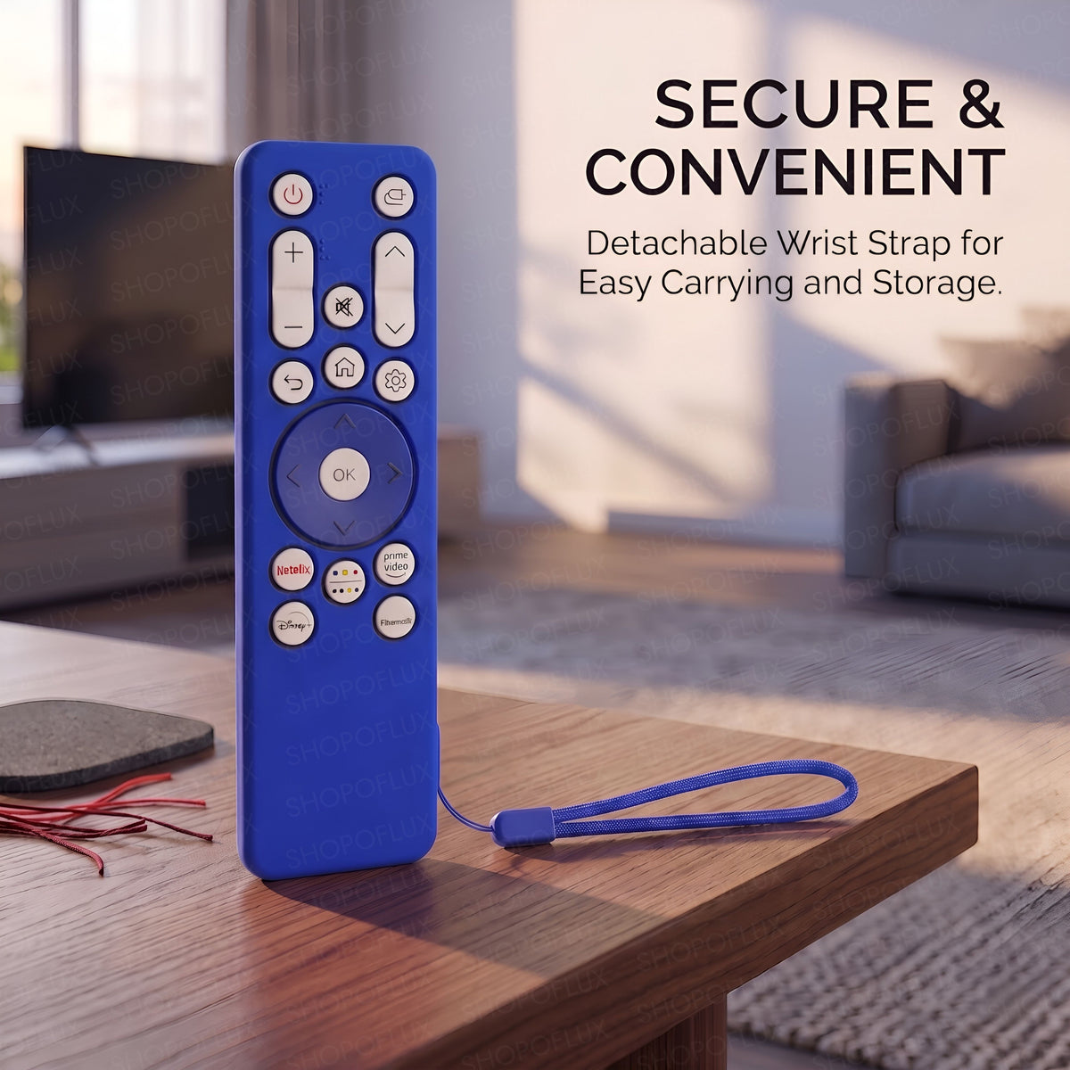 Covered remote standing on a table with its wrist strap